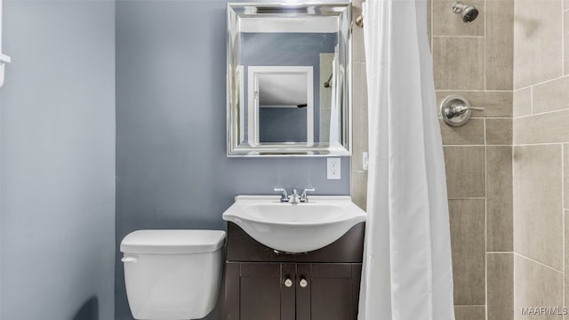 bathroom with vanity, a shower with curtain, and toilet