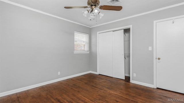 unfurnished bedroom with ceiling fan, crown molding, and dark hardwood / wood-style flooring