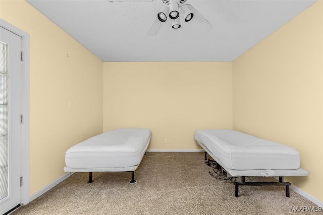 sitting room featuring carpet and ceiling fan