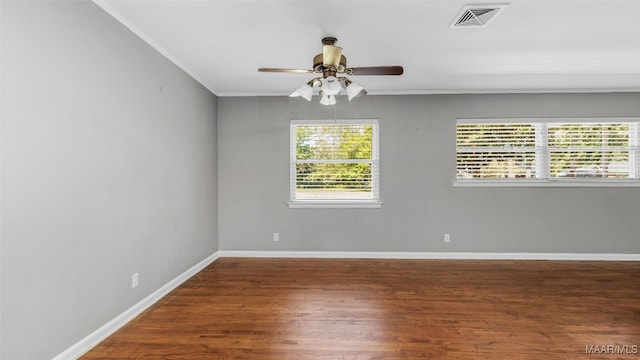 unfurnished room featuring crown molding, dark wood-type flooring, and ceiling fan