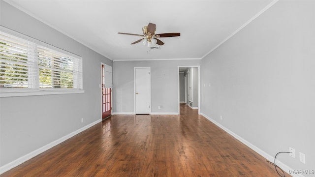 spare room with dark wood-type flooring, crown molding, and ceiling fan