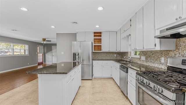 kitchen featuring white cabinetry, sink, range hood, light hardwood / wood-style floors, and stainless steel appliances