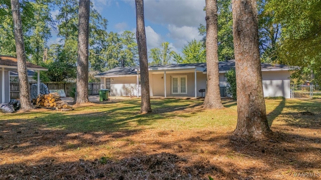 view of front of house featuring a front yard and french doors