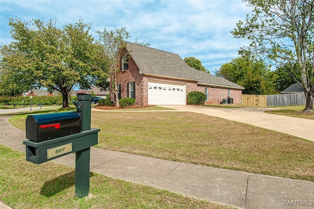 view of front of home with central AC, a front yard, and a garage