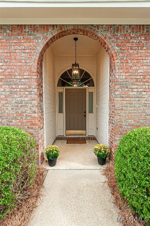 view of exterior entry featuring covered porch