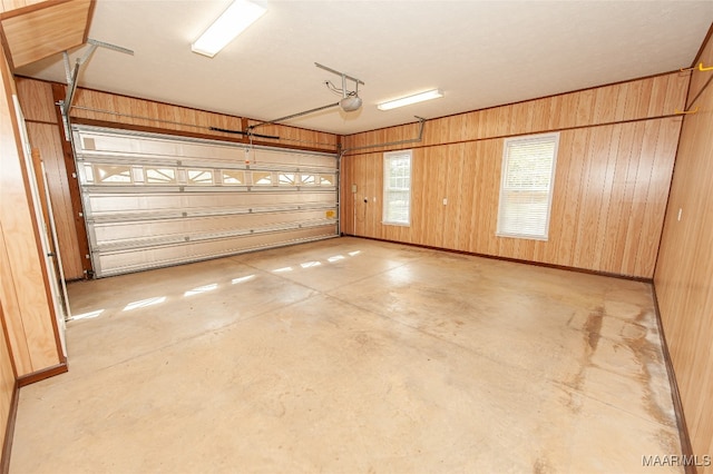 garage with wooden walls and a garage door opener