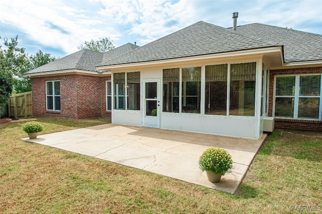 back of house with a patio, a sunroom, and a yard