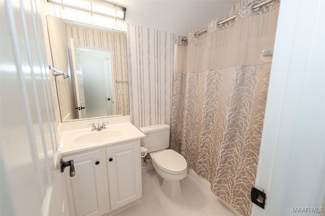 bathroom featuring toilet, vanity, a shower with shower curtain, and tile patterned flooring