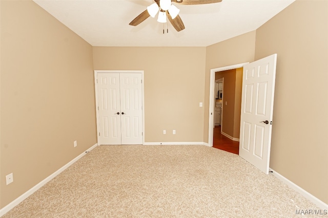 unfurnished bedroom featuring carpet, a closet, and ceiling fan