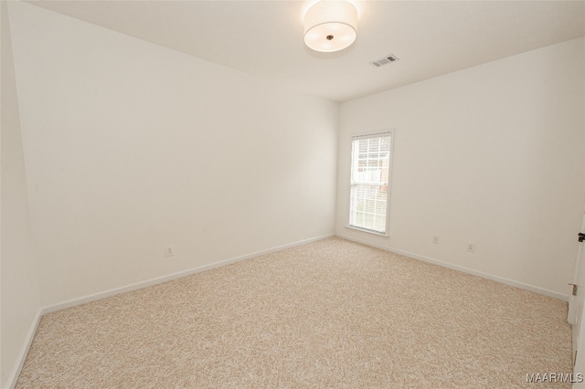 spare room with light colored carpet