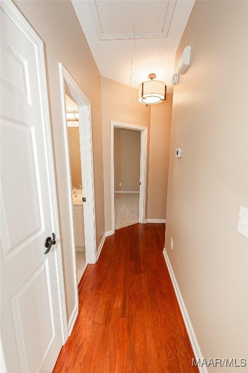 hallway featuring dark hardwood / wood-style floors and a textured ceiling