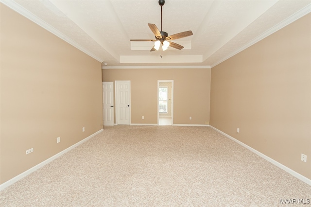 unfurnished room with ceiling fan, a textured ceiling, a tray ceiling, ornamental molding, and carpet floors