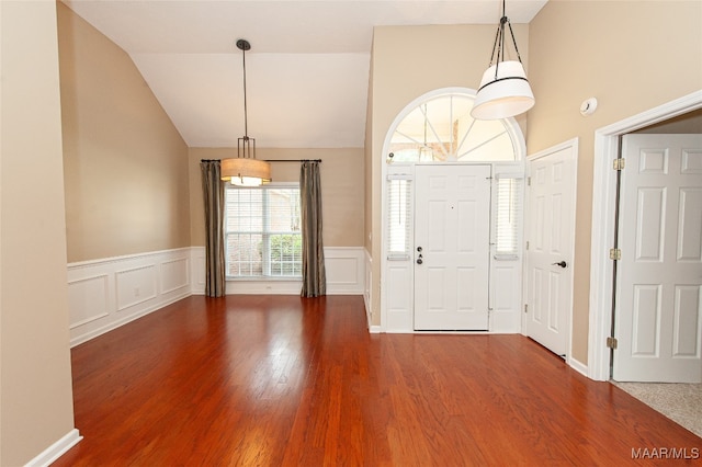 foyer with vaulted ceiling and dark hardwood / wood-style floors