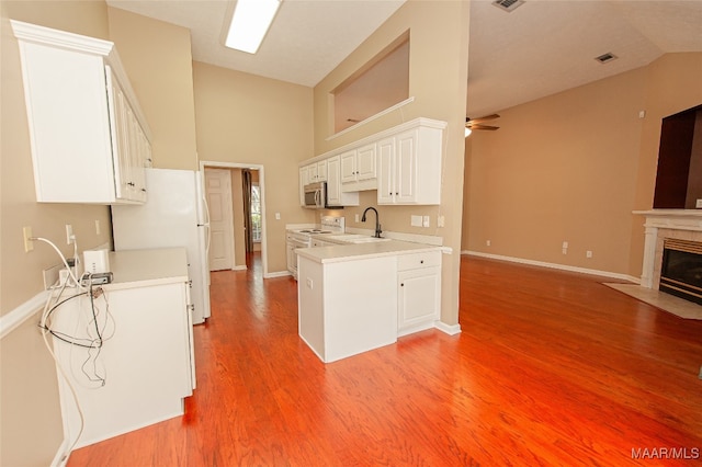 kitchen with light hardwood / wood-style flooring, sink, white cabinets, high vaulted ceiling, and ceiling fan