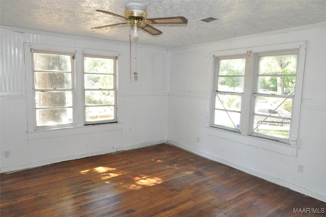 unfurnished room with ceiling fan, ornamental molding, a wealth of natural light, and dark hardwood / wood-style floors