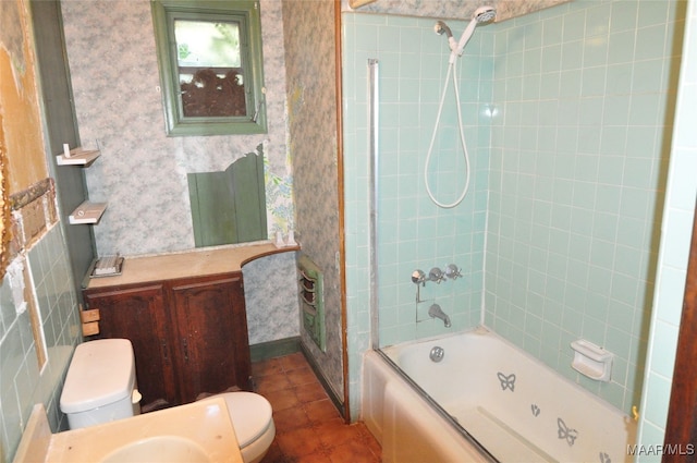 bathroom featuring toilet and tiled shower / bath combo