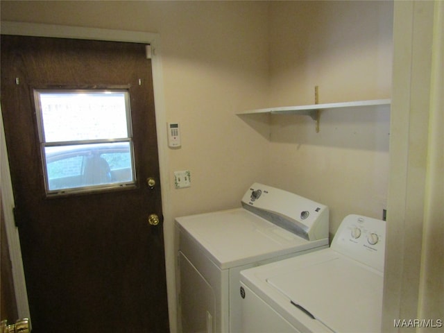 washroom with washing machine and clothes dryer