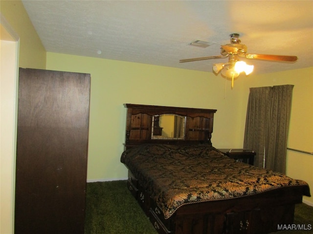 carpeted bedroom featuring a textured ceiling and ceiling fan