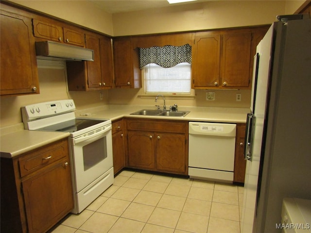 kitchen featuring sink, white appliances, and light tile patterned floors