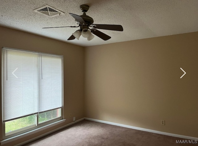 unfurnished room featuring ceiling fan, a textured ceiling, and carpet floors