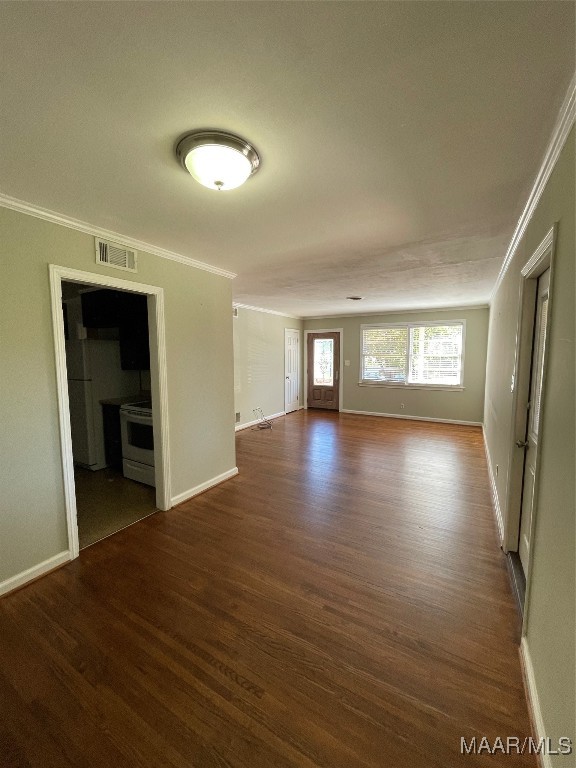 unfurnished room with ornamental molding and dark hardwood / wood-style flooring