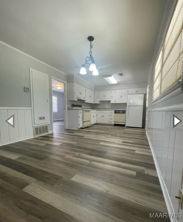 kitchen featuring white cabinetry, dark hardwood / wood-style floors, decorative light fixtures, and white appliances