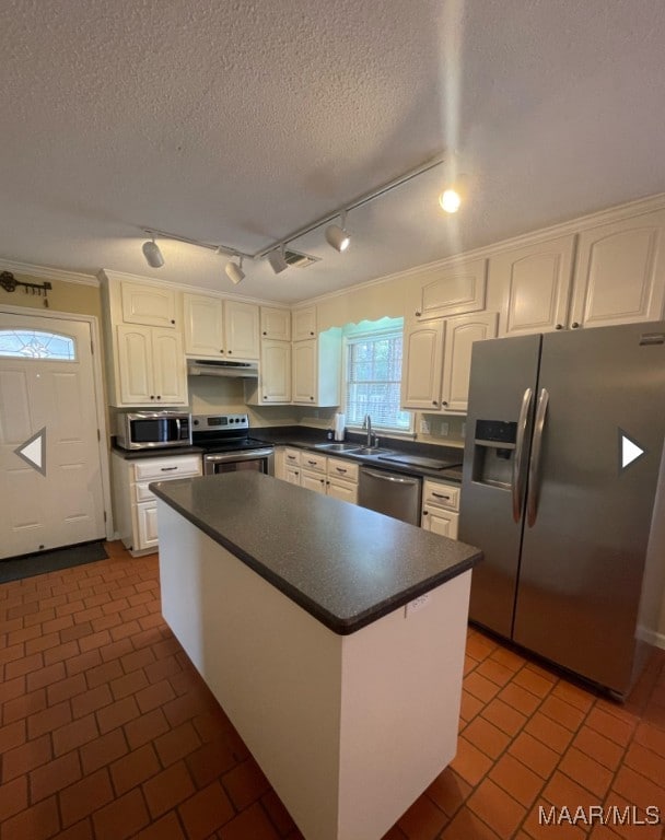 kitchen featuring ornamental molding, appliances with stainless steel finishes, a textured ceiling, and white cabinets