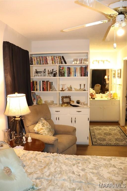 sitting room with hardwood / wood-style flooring and ceiling fan