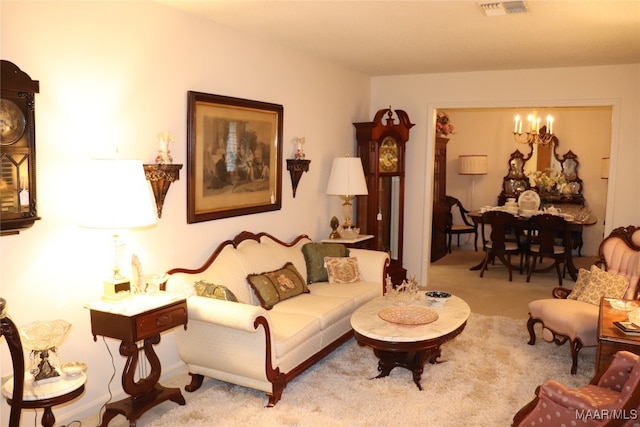 living room featuring light carpet and a chandelier