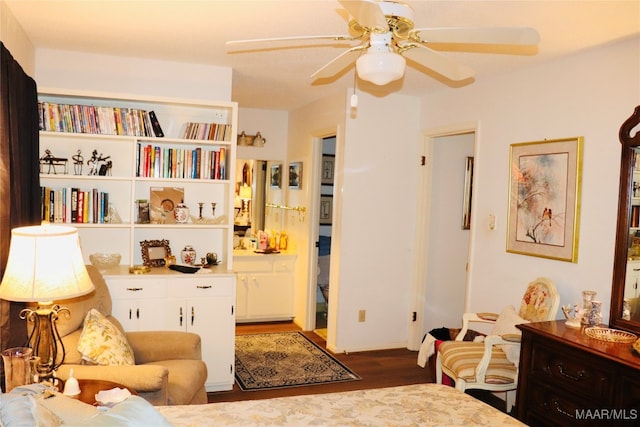 living area with ceiling fan and dark hardwood / wood-style flooring