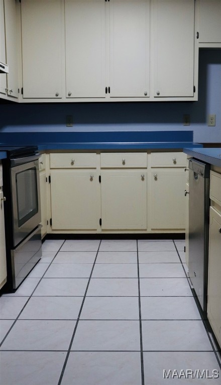 kitchen featuring light tile patterned floors and appliances with stainless steel finishes