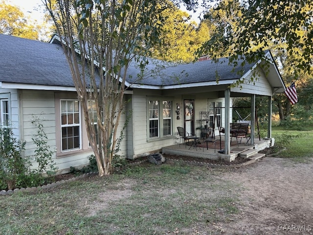 back of house featuring a porch