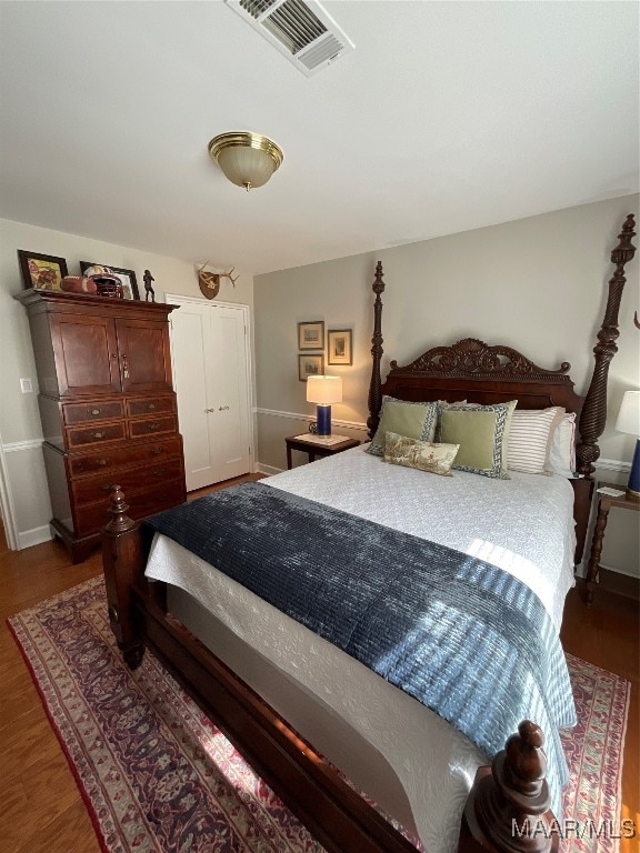 bedroom with dark hardwood / wood-style flooring