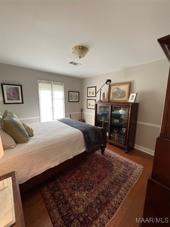 bedroom featuring dark wood-type flooring