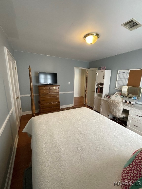 bedroom with hardwood / wood-style flooring