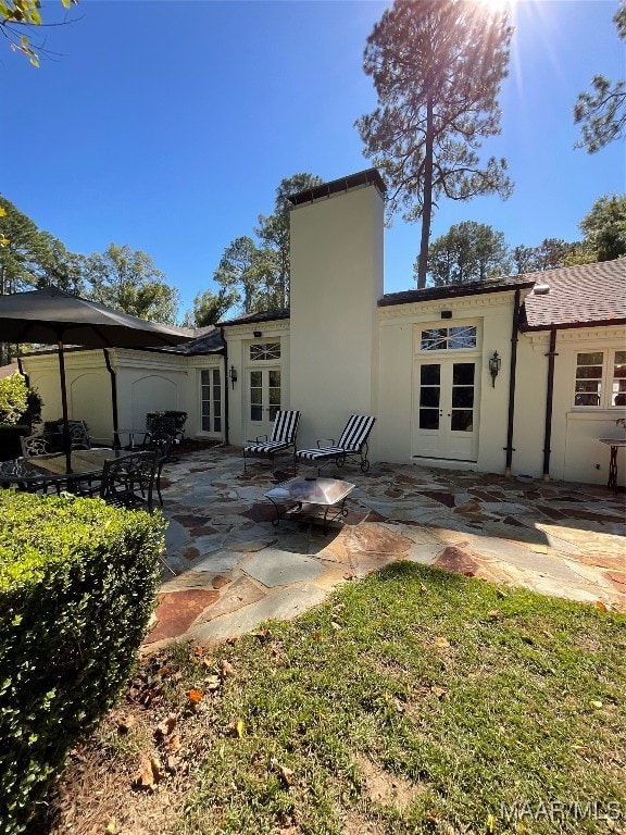 rear view of property with a patio area, french doors, and a gazebo