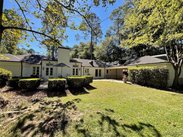 back of property featuring a lawn