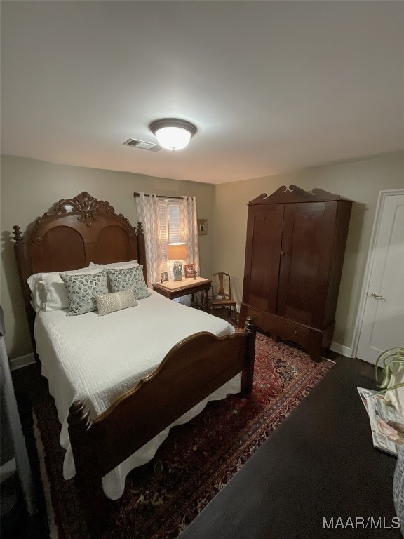 bedroom featuring dark carpet