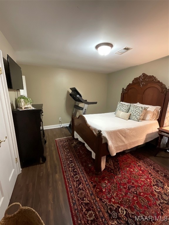 bedroom featuring dark hardwood / wood-style flooring