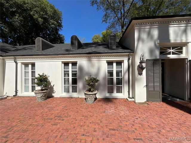 rear view of house with french doors and a patio area