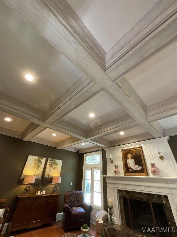 living room featuring french doors, a high end fireplace, coffered ceiling, beamed ceiling, and crown molding