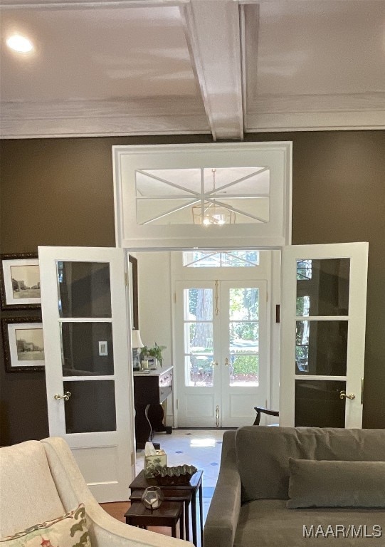 entryway with french doors, crown molding, and beamed ceiling