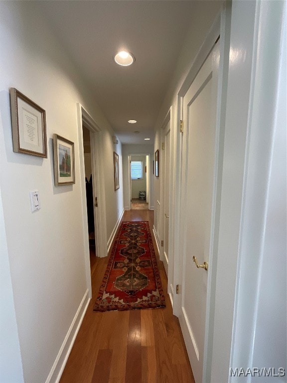 corridor with wood-type flooring