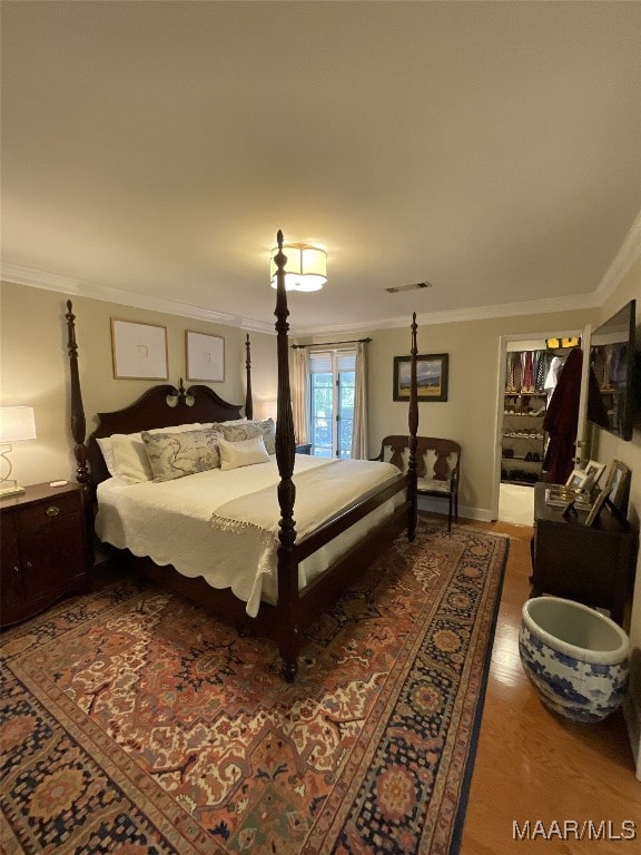 bedroom featuring crown molding and hardwood / wood-style flooring