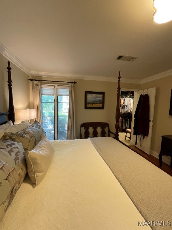 bedroom featuring crown molding, hardwood / wood-style flooring, and access to exterior