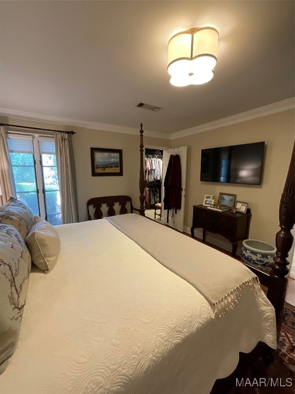 bedroom featuring ornamental molding and access to outside