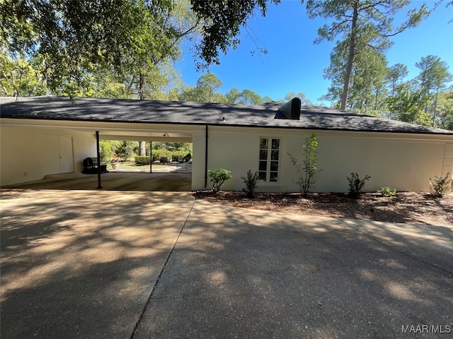 rear view of property with a carport