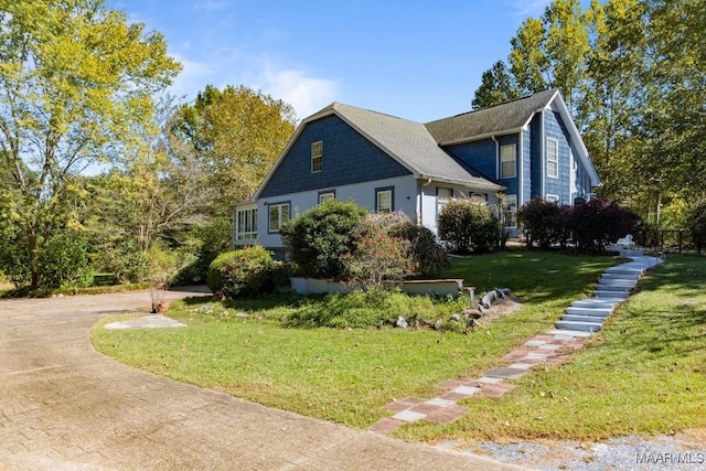 view of property exterior with a lawn