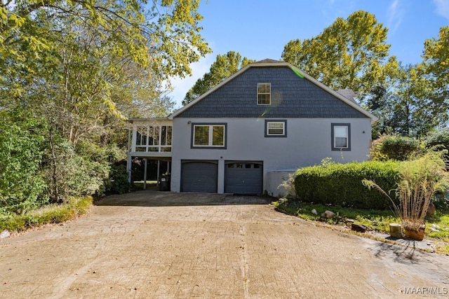 view of home's exterior with a garage and a carport