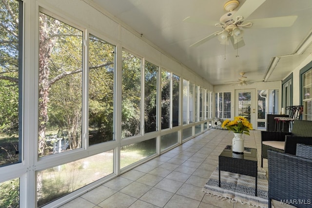 unfurnished sunroom featuring ceiling fan